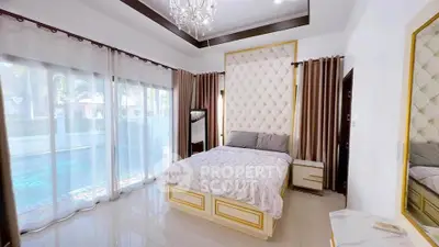 Luxurious bedroom with pool view, elegant decor, and plush bedding in a modern home.