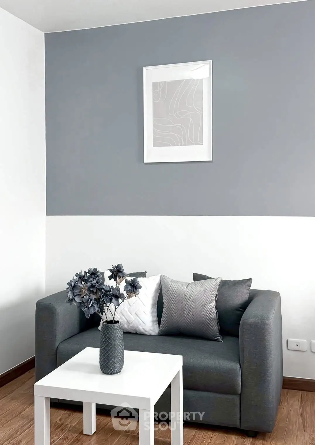 Modern living room with stylish gray sofa and decorative pillows