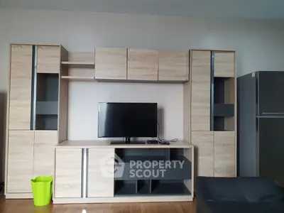Modern living room with sleek wooden entertainment center and flat-screen TV