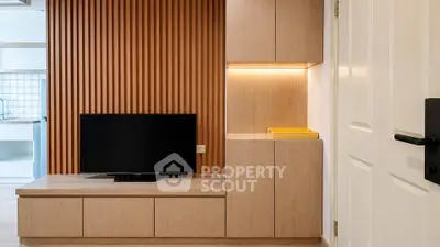 Modern living room with sleek wooden paneling and built-in TV unit