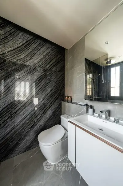 Luxurious modern bathroom with sleek marble walls and contemporary fixtures