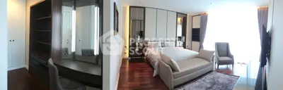 Luxurious bedroom with elegant decor and spacious layout, featuring a cozy seating area and ample natural light.