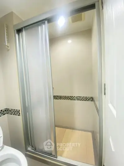 Modern bathroom with sleek shower enclosure and stylish tile accents.