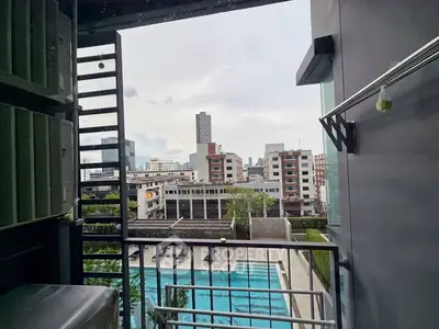 Modern urban balcony with city view and pool, ideal for relaxation.