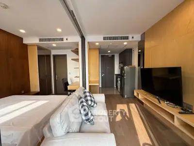 Modern studio apartment with open layout, featuring a cozy living area, sleek kitchen, and stylish decor.