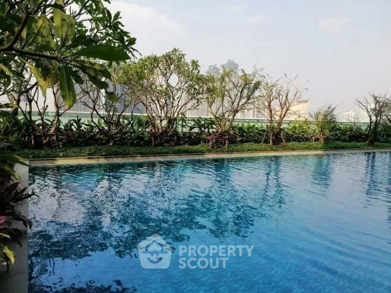 Luxurious outdoor pool with lush greenery and serene ambiance