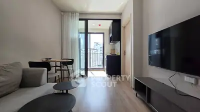 Modern living room with sleek furniture and balcony access in a stylish apartment.