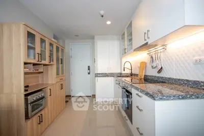 Modern kitchen with sleek cabinets and granite countertops in a stylish apartment