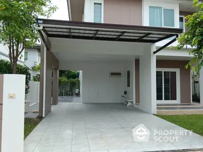 Modern house exterior with spacious carport and lush greenery