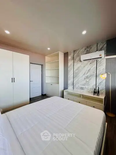Modern bedroom with sleek design and built-in storage solutions.
