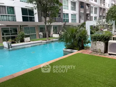 Modern apartment complex with inviting swimming pool and lush greenery