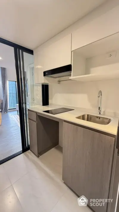 Modern compact kitchen with sleek cabinetry and stainless steel sink