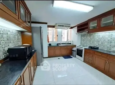Spacious kitchen with modern appliances and elegant cabinetry in a well-lit interior.