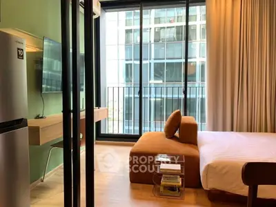 Modern bedroom with floor-to-ceiling windows and stylish furniture in urban apartment.