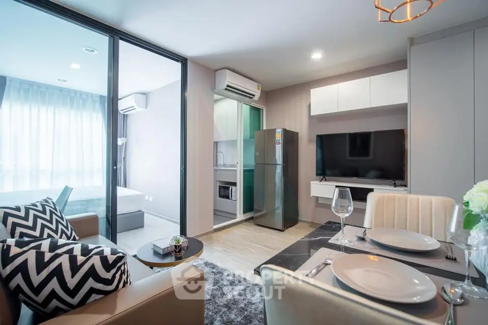 Modern open-plan living room with stylish decor and kitchen appliances