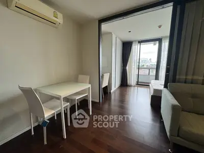 Modern apartment interior with open layout, featuring a cozy living area and a bright bedroom with balcony view.