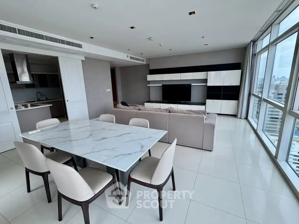 Spacious modern living room with city view, open layout, and elegant dining area.