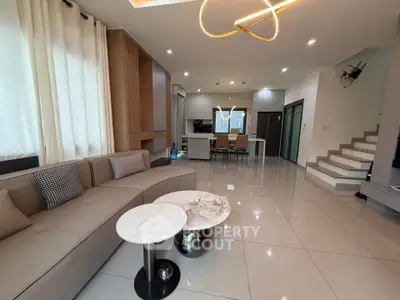 Spacious modern living room with elegant decor and open kitchen layout