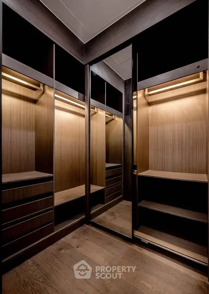 Luxurious walk-in closet with elegant wooden finishes and ample storage space.