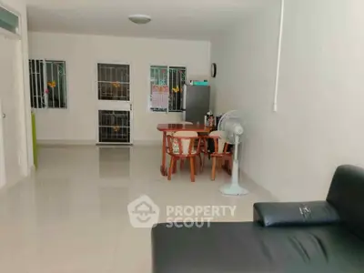 Spacious living room with modern furniture and natural light, perfect for family gatherings.