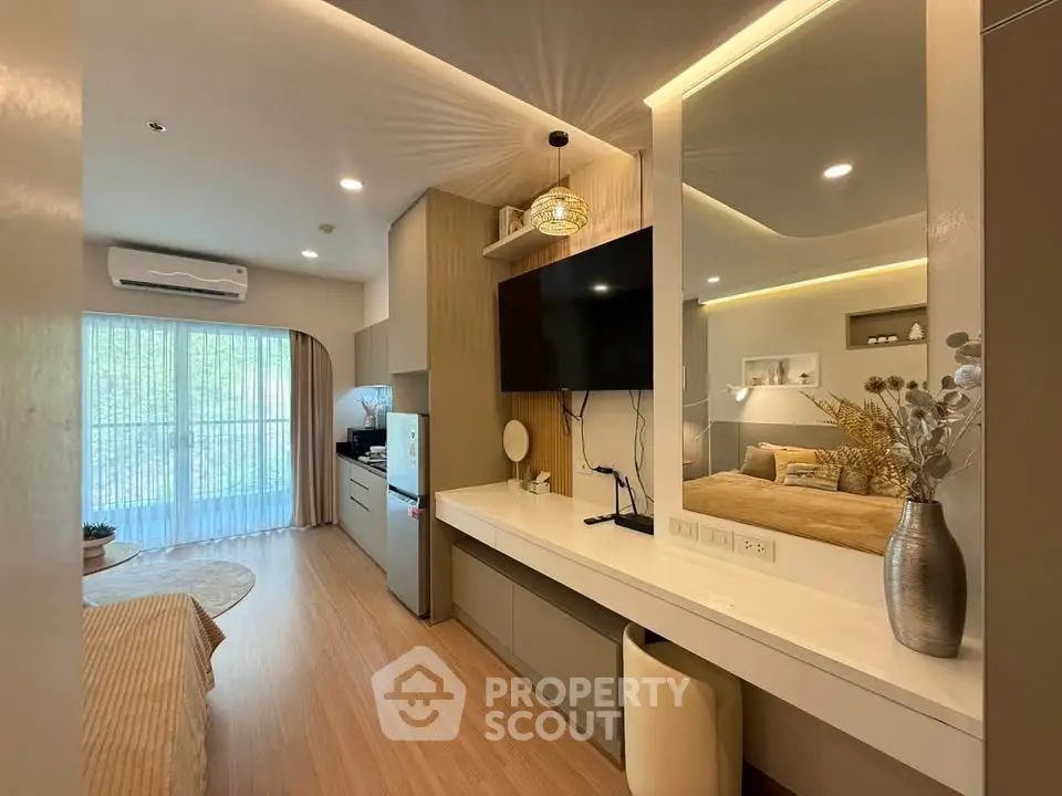 Modern living room with open layout, stylish decor, and natural light from large windows.