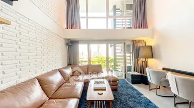 Spacious modern living room with large windows and stylish decor in urban apartment.