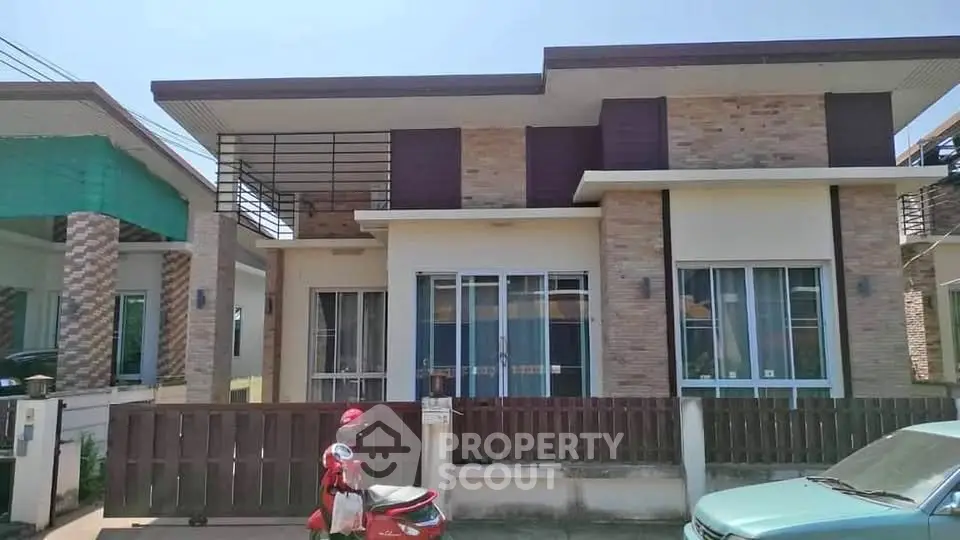 Modern single-story house with brick facade and large windows