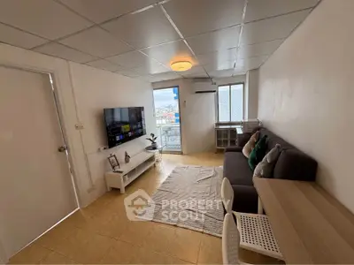Modern living room with city view, featuring sleek furniture and natural light.