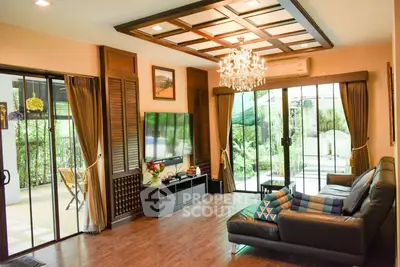 Luxurious living room with elegant chandelier and garden view