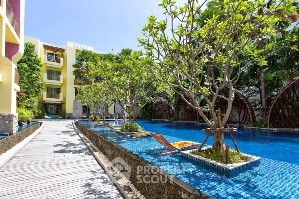Luxurious poolside view with lush greenery and modern architecture, perfect for relaxation and leisure.