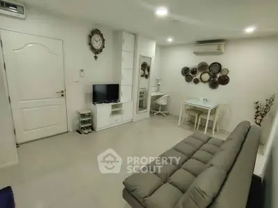 Modern living room with stylish decor and comfortable seating in a cozy apartment.