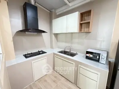 Modern kitchen with gas stove and microwave in sleek design