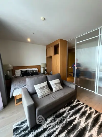 Modern studio apartment with cozy bed and stylish living area