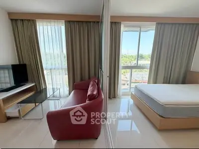 Modern studio apartment with large windows and stylish furnishings