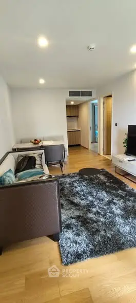 Modern living room with cozy seating and stylish decor in a contemporary apartment.