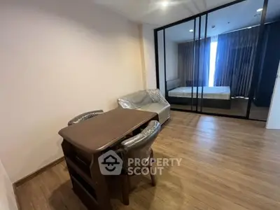 Modern apartment with wooden flooring and glass partitioned bedroom