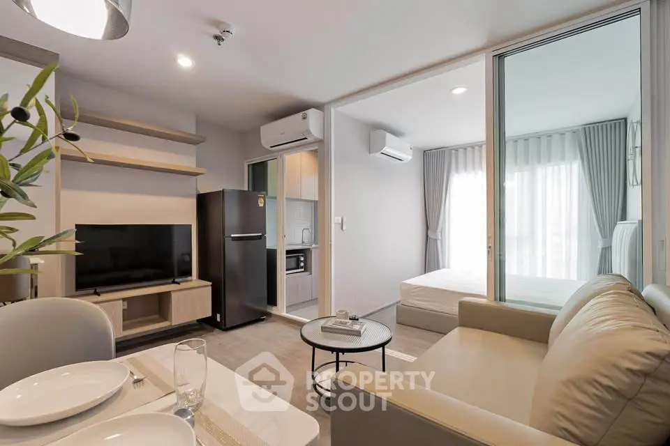 Modern open-plan living room with kitchen and bedroom in stylish apartment