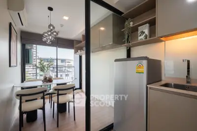 Modern kitchen with dining area and balcony view in stylish apartment
