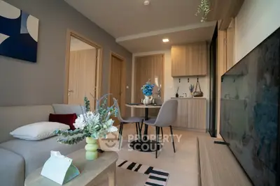 Modern living room with stylish decor and open layout, featuring a cozy dining area and contemporary furniture.