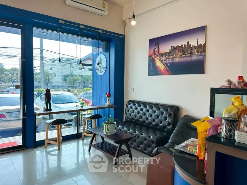 Charming living room with modern decor and large window view.