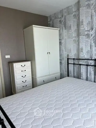 Chic bedroom with modern wallpaper and stylish white furniture, perfect for urban living.