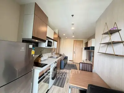 Modern kitchen with sleek appliances and dining area in a stylish apartment.