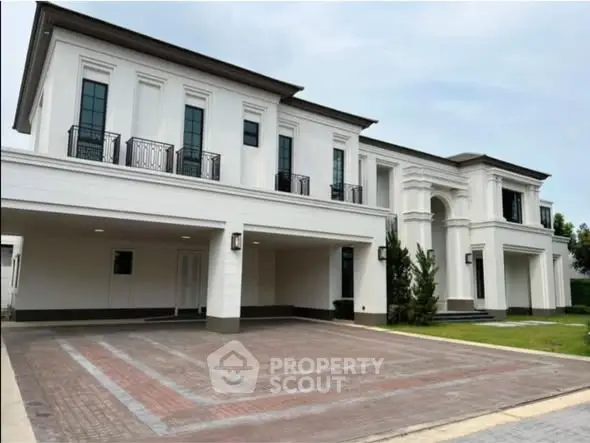 Luxurious modern mansion with spacious driveway and elegant architectural design.