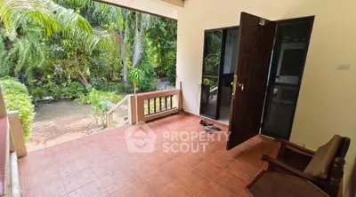 Charming open terrace with lush garden view, perfect for relaxation and outdoor enjoyment.