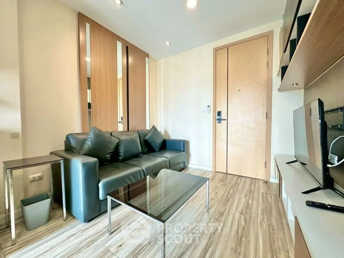 Modern living room with sleek furniture and wooden flooring, perfect for urban living.