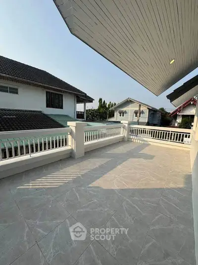 Spacious balcony with tiled flooring and scenic neighborhood view, perfect for relaxation and outdoor gatherings.
