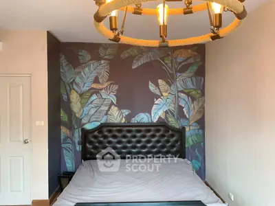 Stylish bedroom with tropical wallpaper and unique lighting fixture