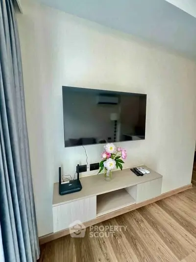 Modern living room with wall-mounted TV and stylish wooden console