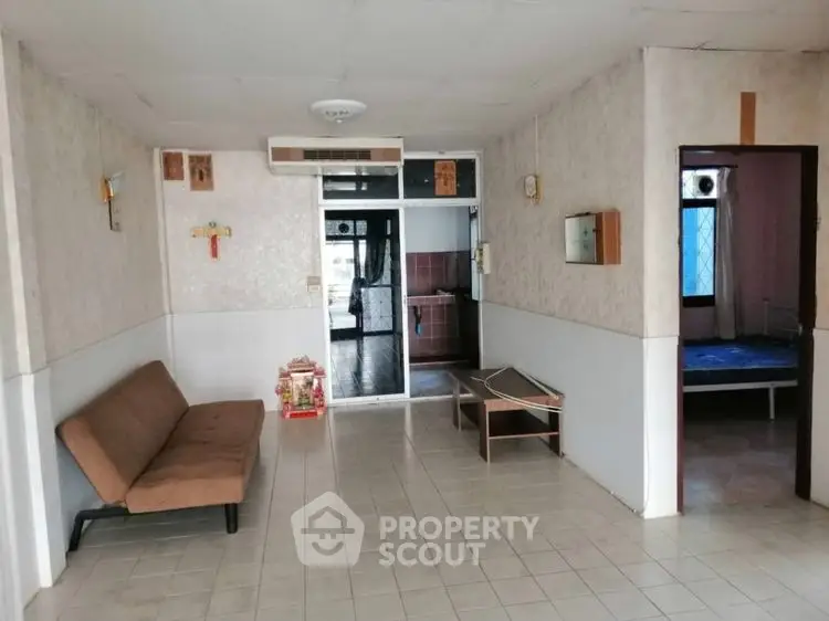 Spacious living area with sofa and tiled flooring in a cozy home