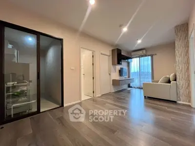 Spacious modern living room with sleek flooring and stylish decor, perfect for comfortable living.